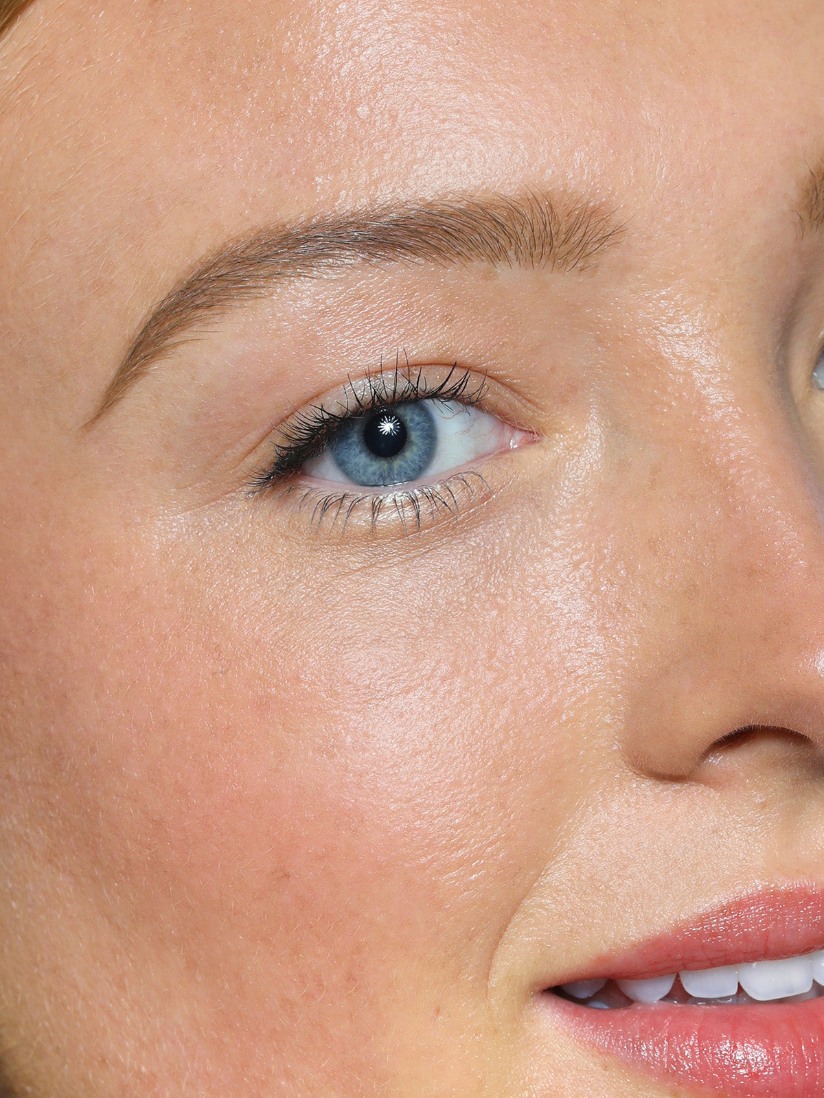 CLOSE UP OF REFY BROW PENCIL IN LIGHT ON MODEL WITH LIGHT EYEBROWS